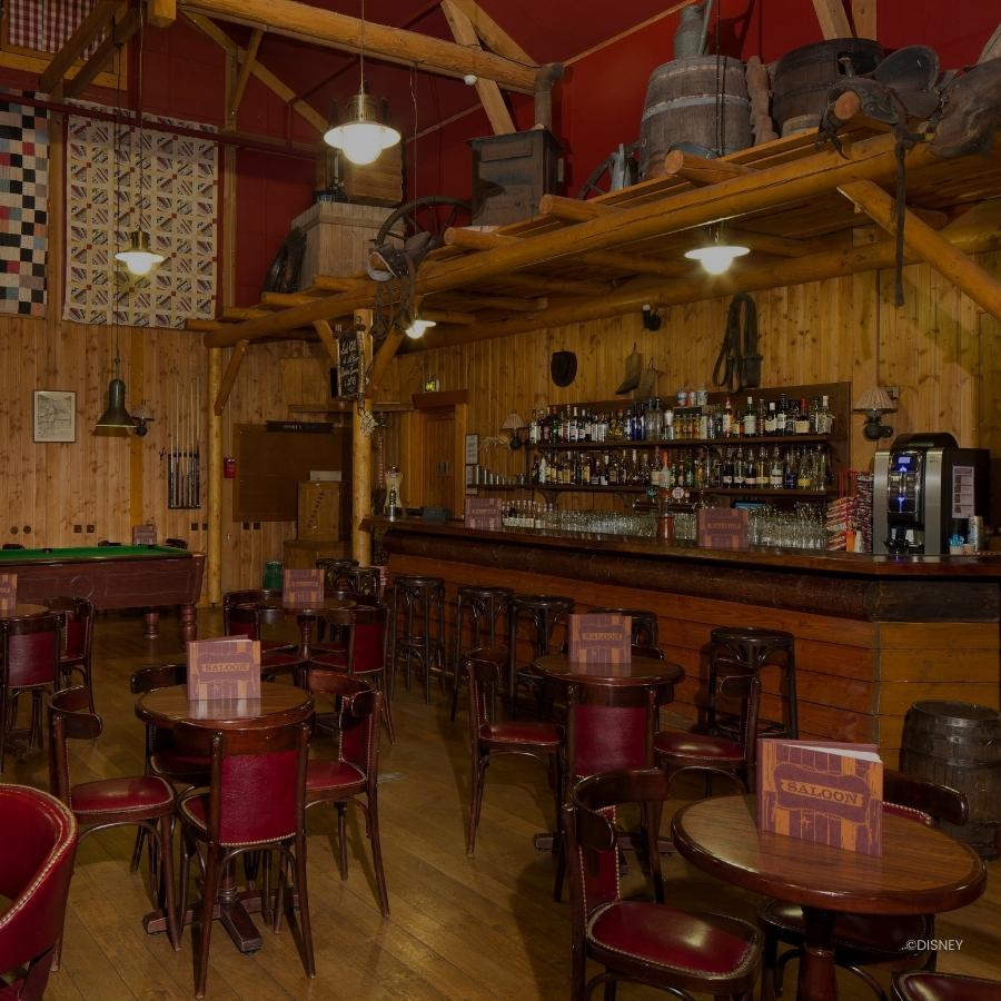 Crockett's Saloon bar met flessen drank en tafels en stoelen